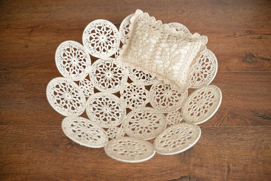 Set of white lace doilies on a wooden surface