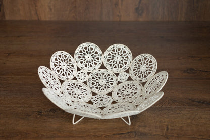 Decorative white lace bowl on a wooden surface