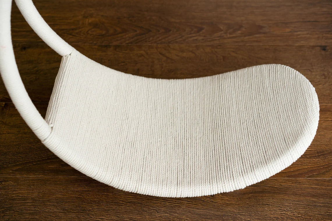 White woven chair seat on a wooden floor