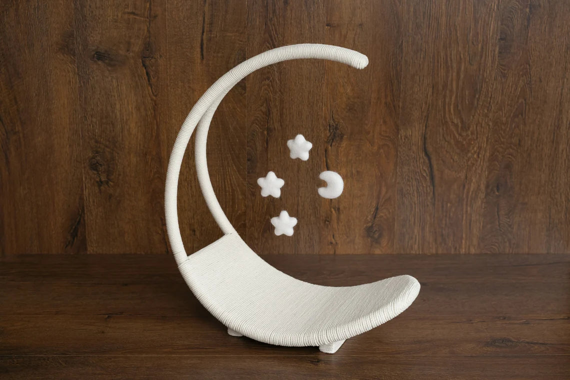 White ceramic moon-shaped shelf with stars on a wooden background