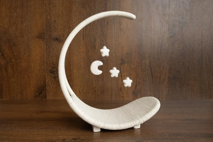 Decorative moon-shaped stand with stars on a wooden background
