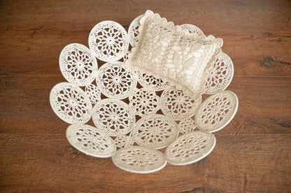 Set of white lace doilies on a wooden surface