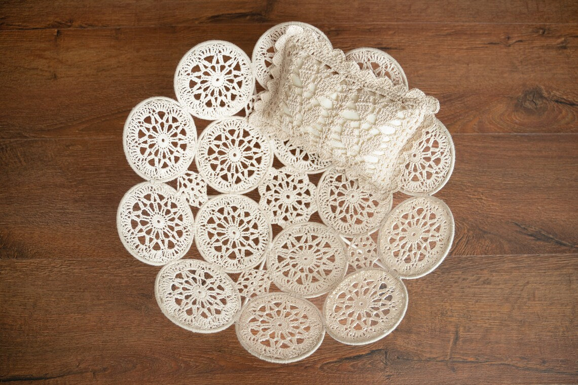 Set of white lace doilies on a wooden surface