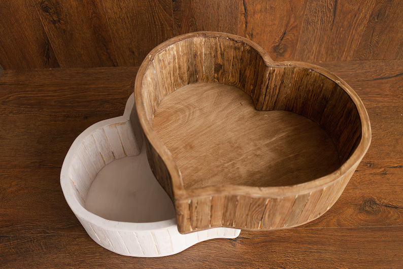 Heart-shaped wooden pet bed on a wooden floor