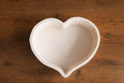 Heart-shaped cookie cutter on a wooden surface